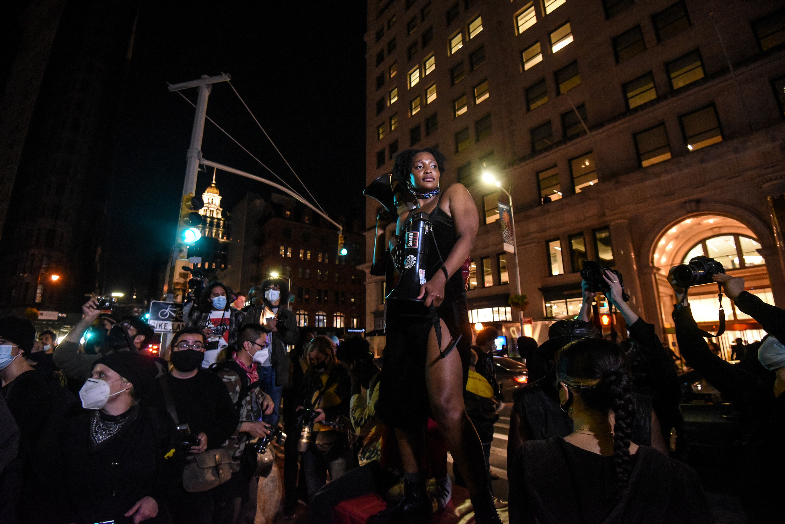 People dance to music in the street during an anti-Trump pro-Biden rally in that started in Washington Square Park but moved around the East Village in New York, New York, U.S. October 25, 2020. A member of the protest group, Warriors in the Garden, deliv